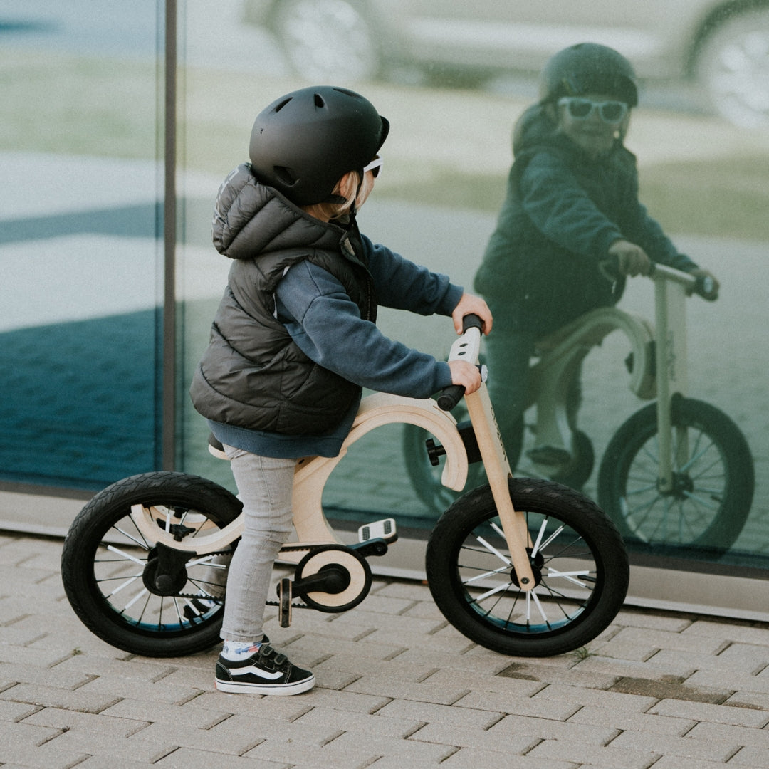 Child riding a leg&go wooden 3-in-1 balance bike