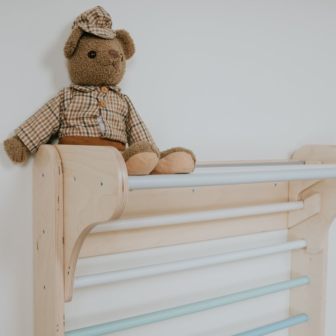 Plush teddy bear placed on pastel-colored Swedish wall for kids’ room decor