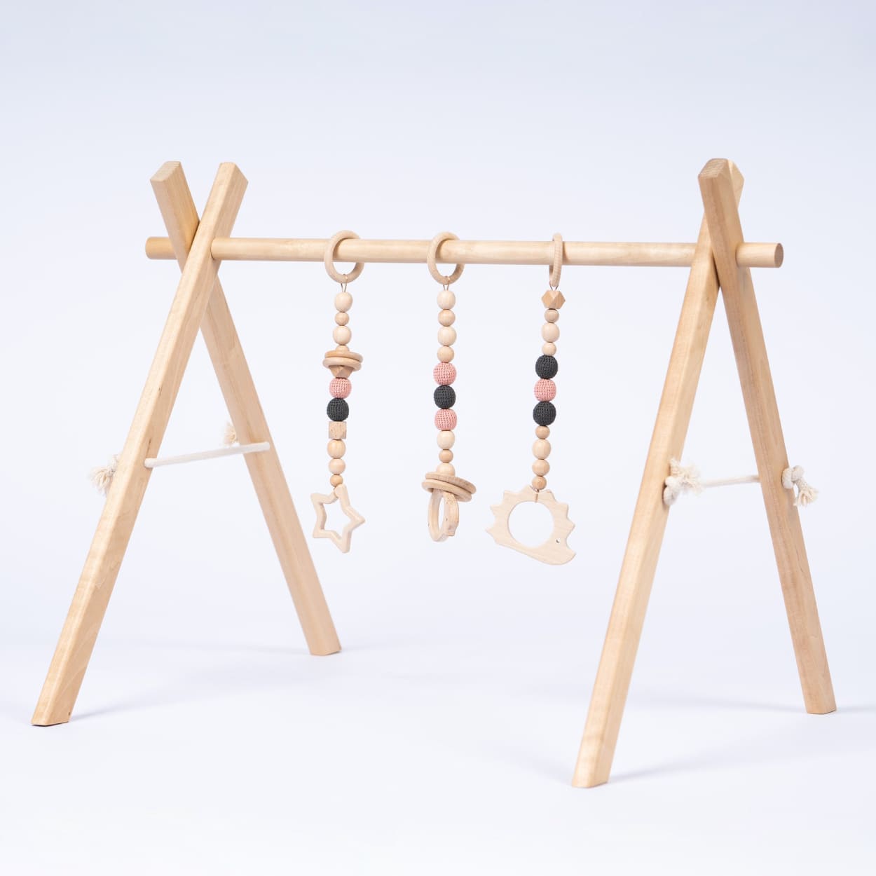 leg&go wood baby gym on white background. Baby playtime made easy.