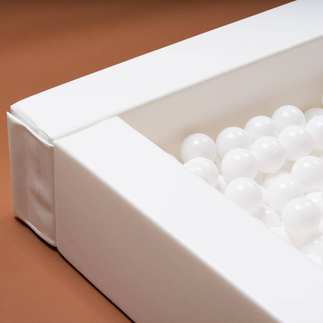 Close-up of the corner of a white soft play ball pit