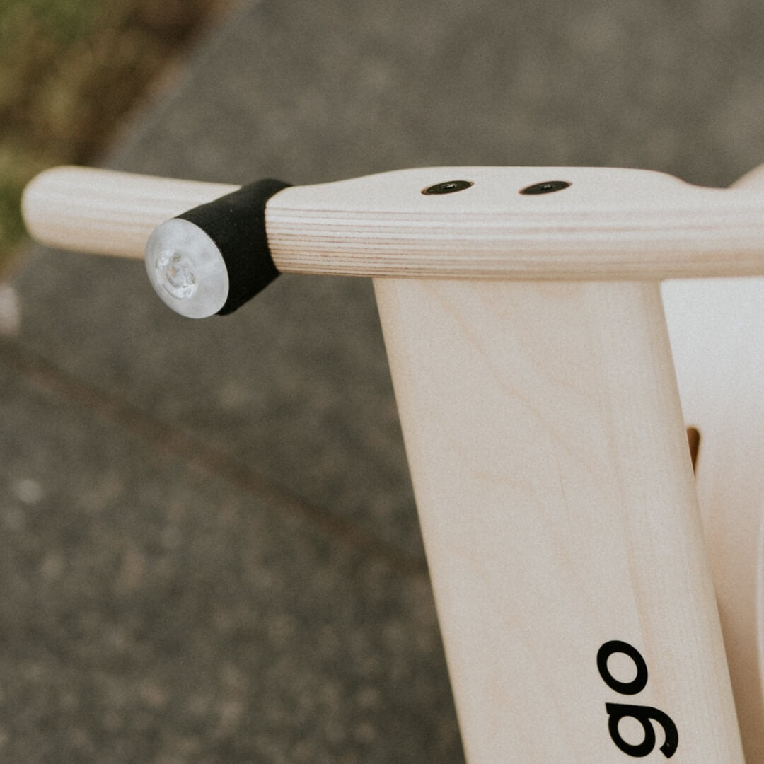 Close-up of detachable bike light on Leg&Go wooden frame for toddlers and kids