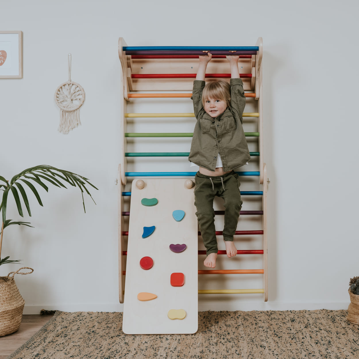Child enjoying Swedish wall set with ramp in multicolor theme