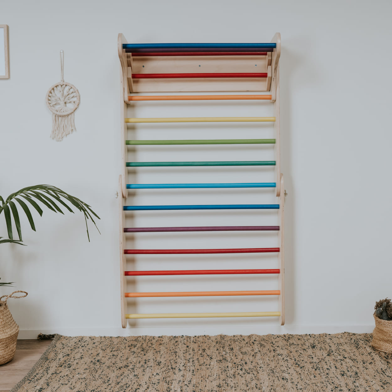 Climbing triangle expanded as Swedish ladder and hanged on the wall.