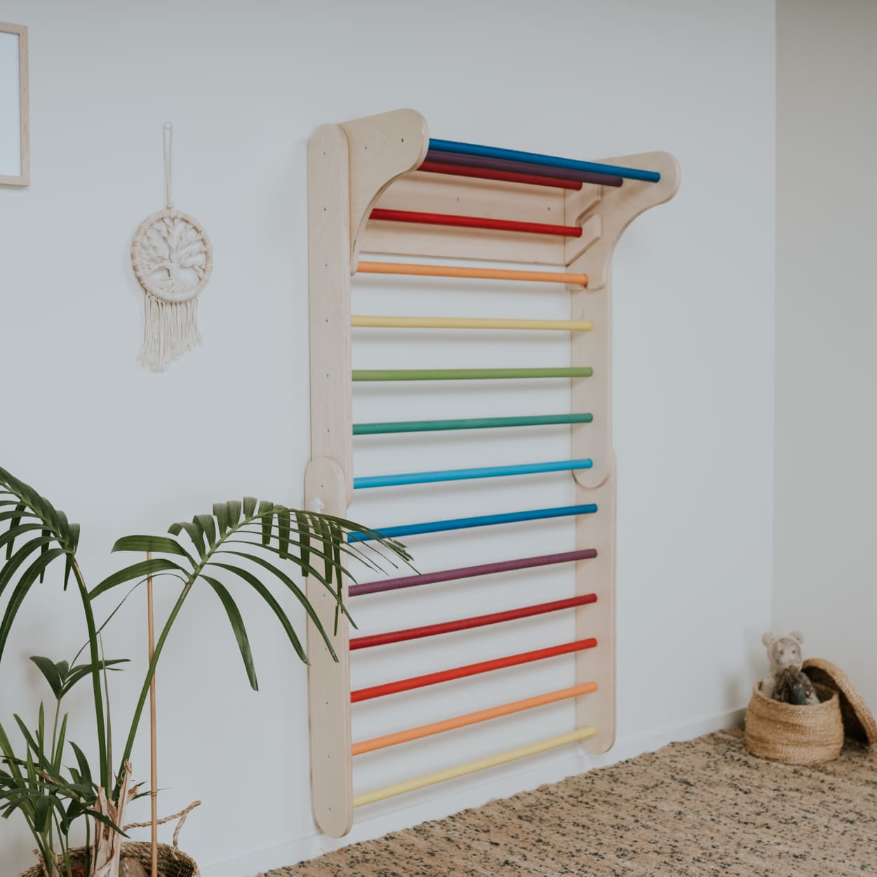 Colorful climbing gym set expanded as Swedish wall with extra hanging bar on the top.