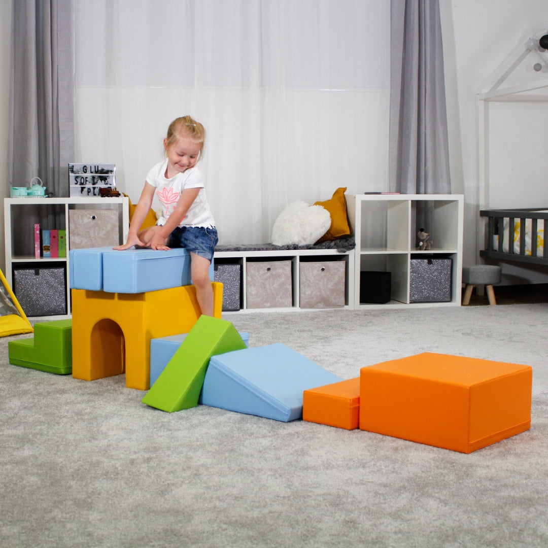 Toddler exploring light colorful Creativity soft play set assembled into playground