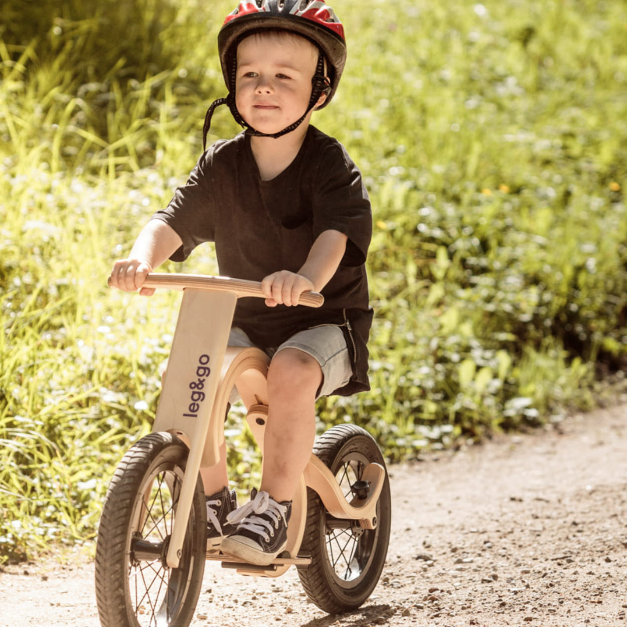 Boy riding a downhill bike in sunny time