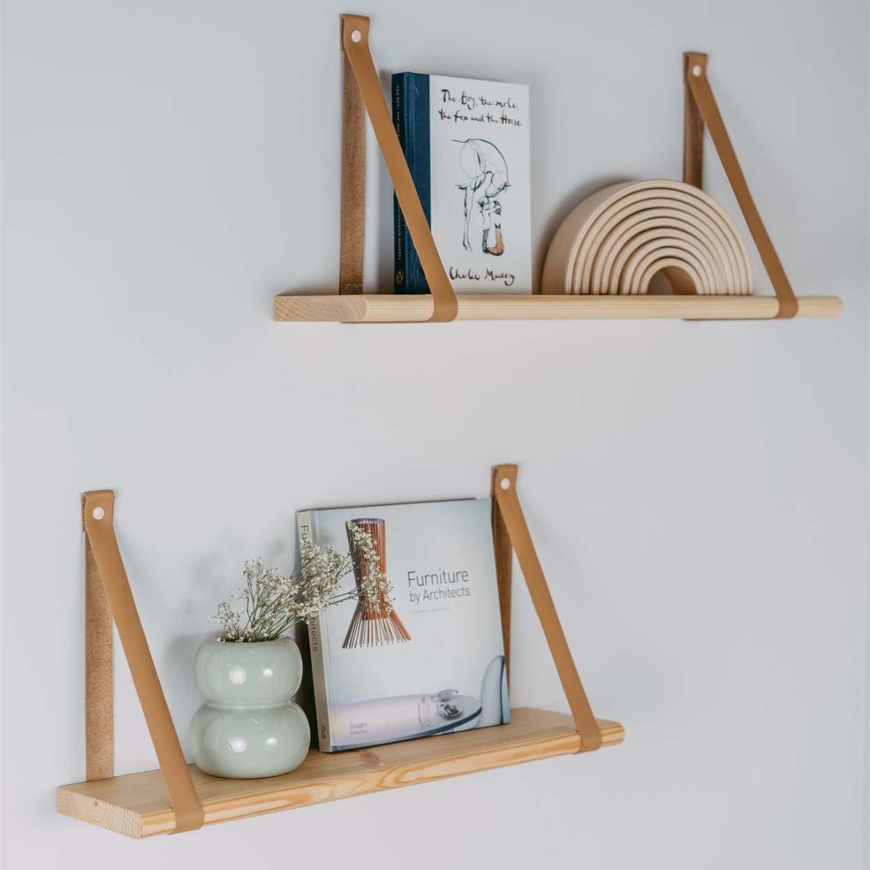 Pine wood floating shelves with home decors on them.