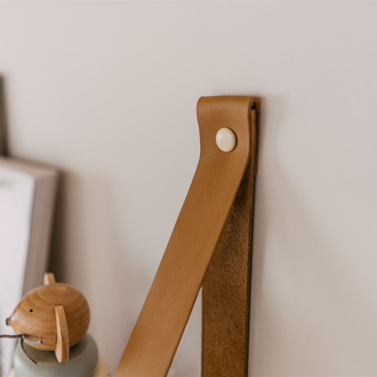 close up of leather strap for the leg&go pine wood floating shelves. 