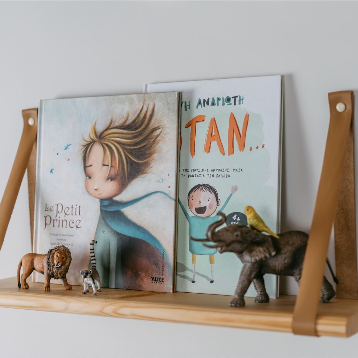 children room decors placed on pine wood floating shelf.