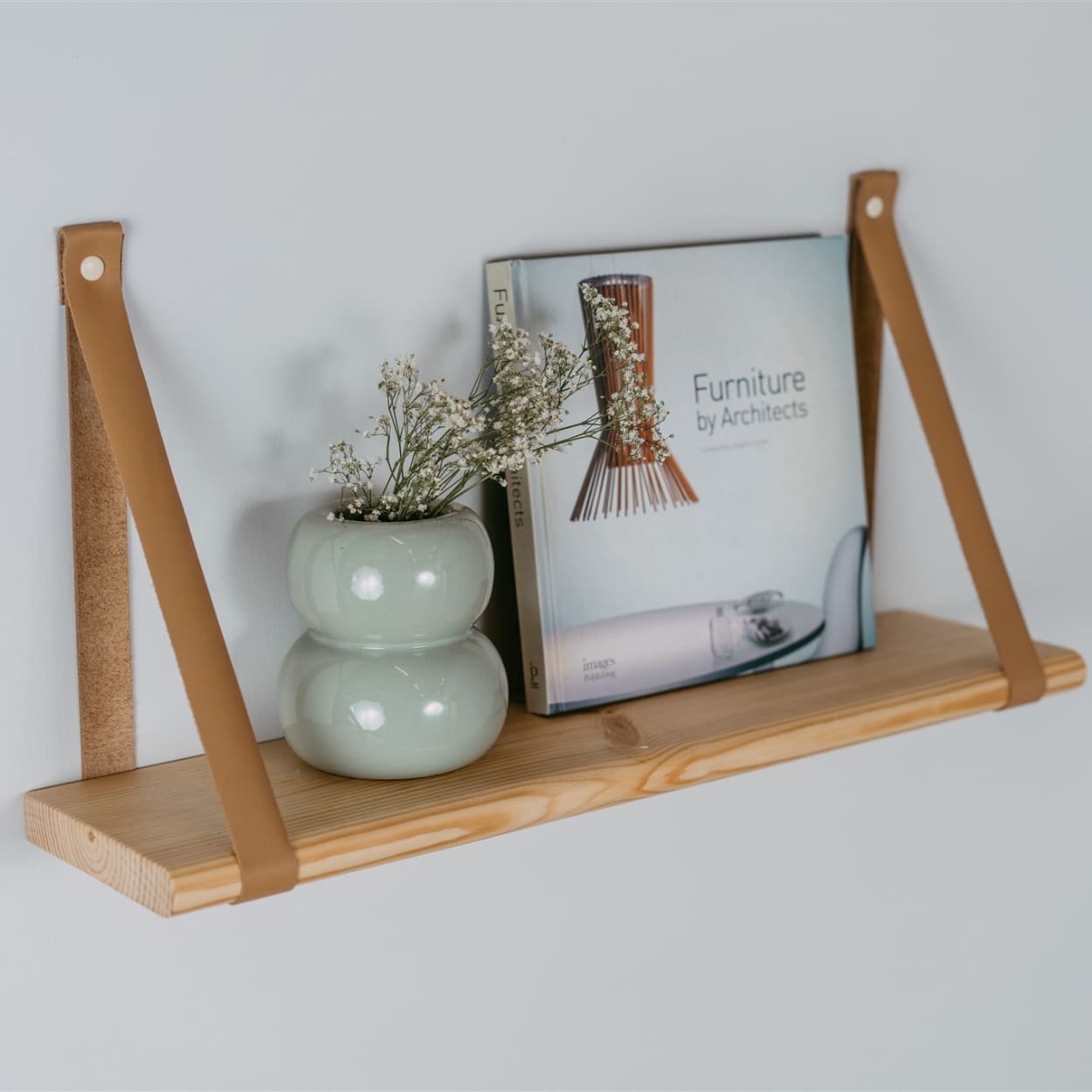 house decorations placed on top of wooden floating shelf