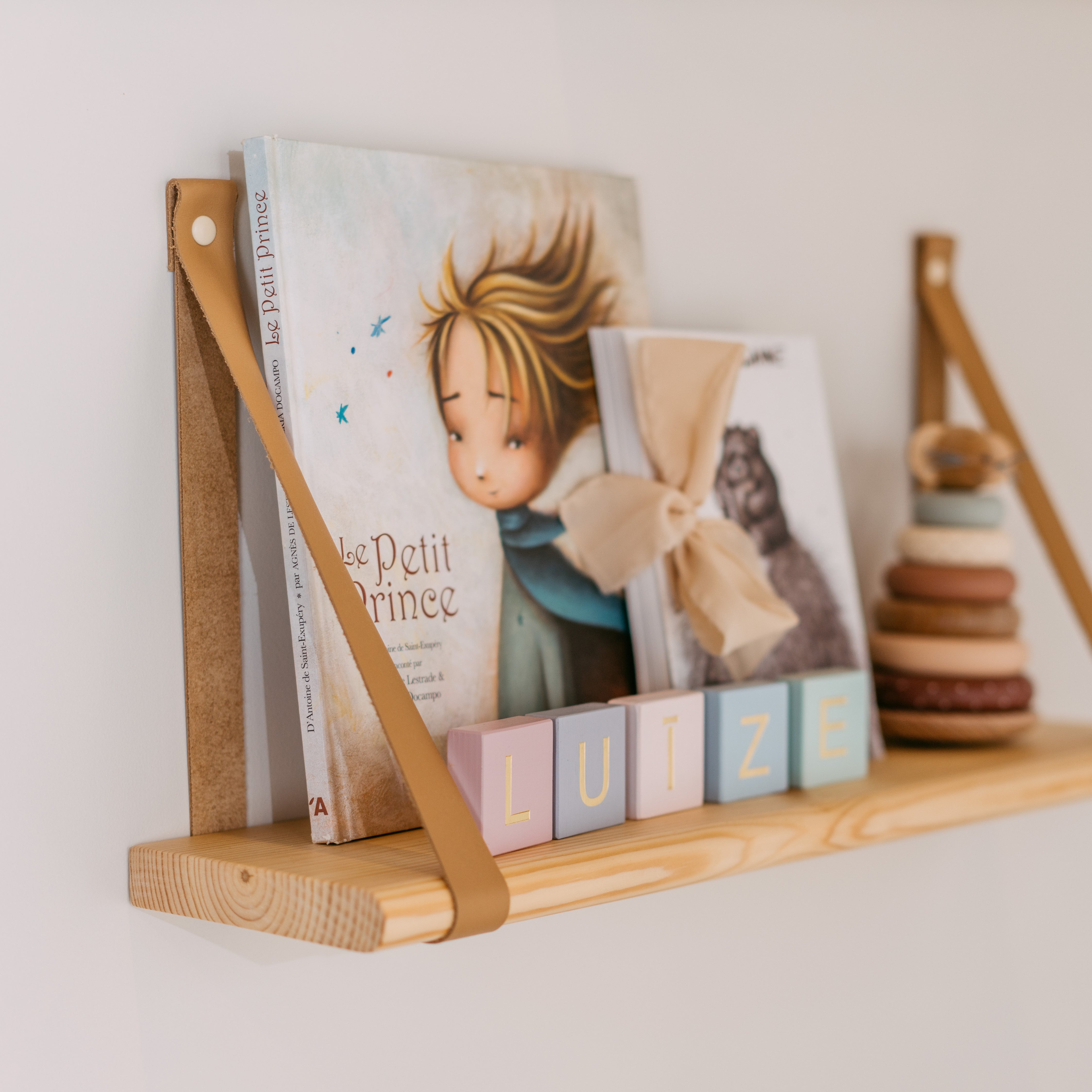 Floating wall shelves with leather straps for books, toys and nursery storage