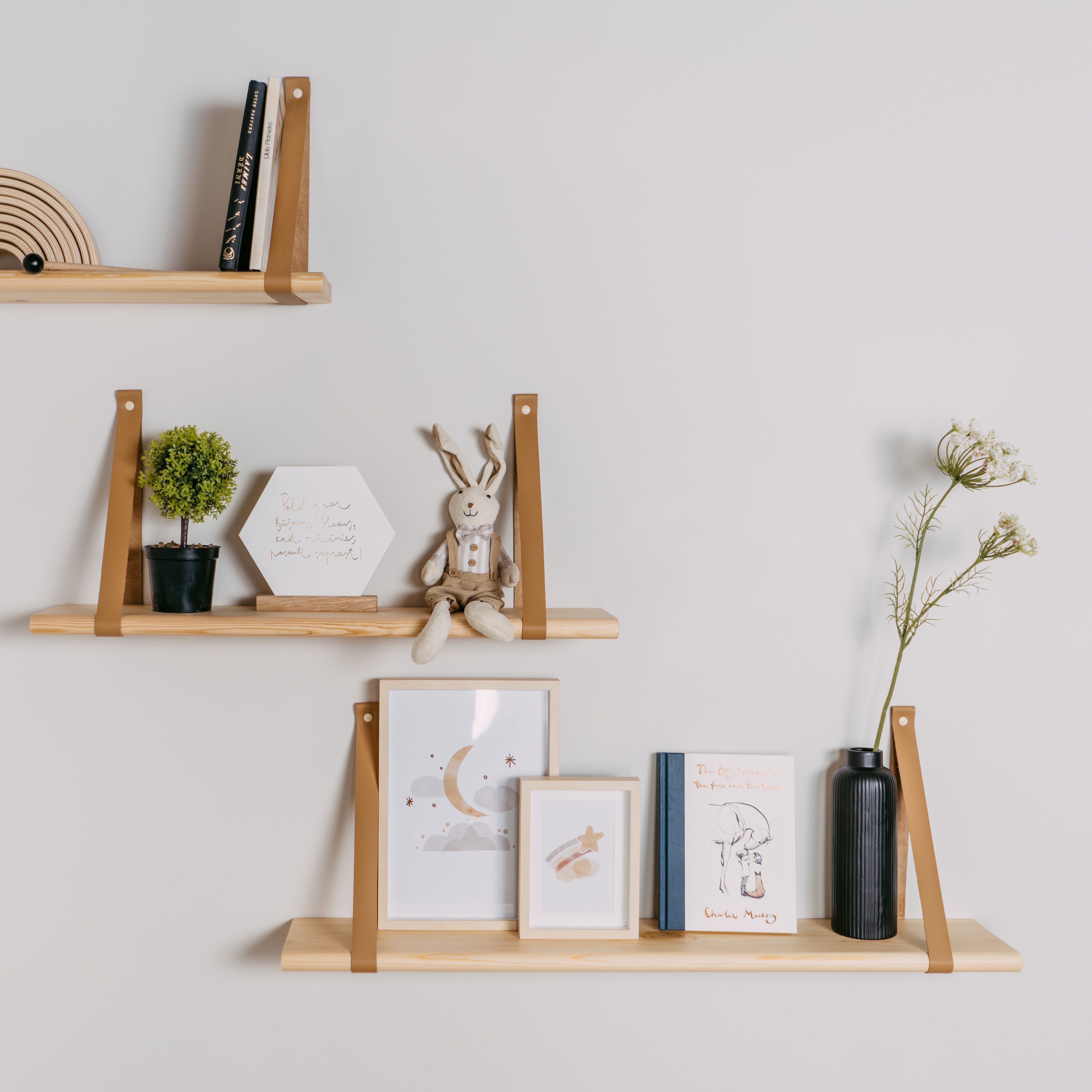 Floating wooden shelves with leather straps for nursery and kids room decor