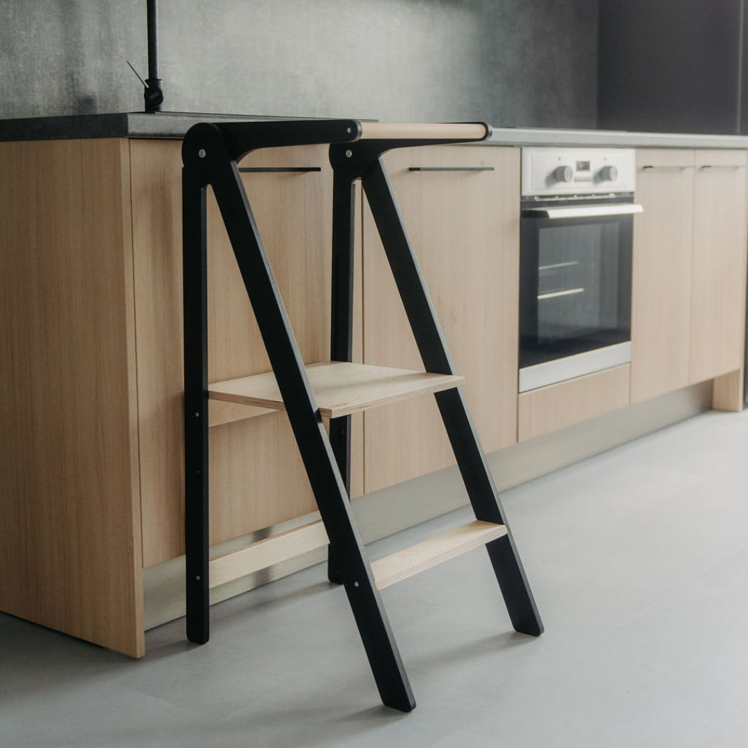 Black and wooden helper tower in a kitchen setting