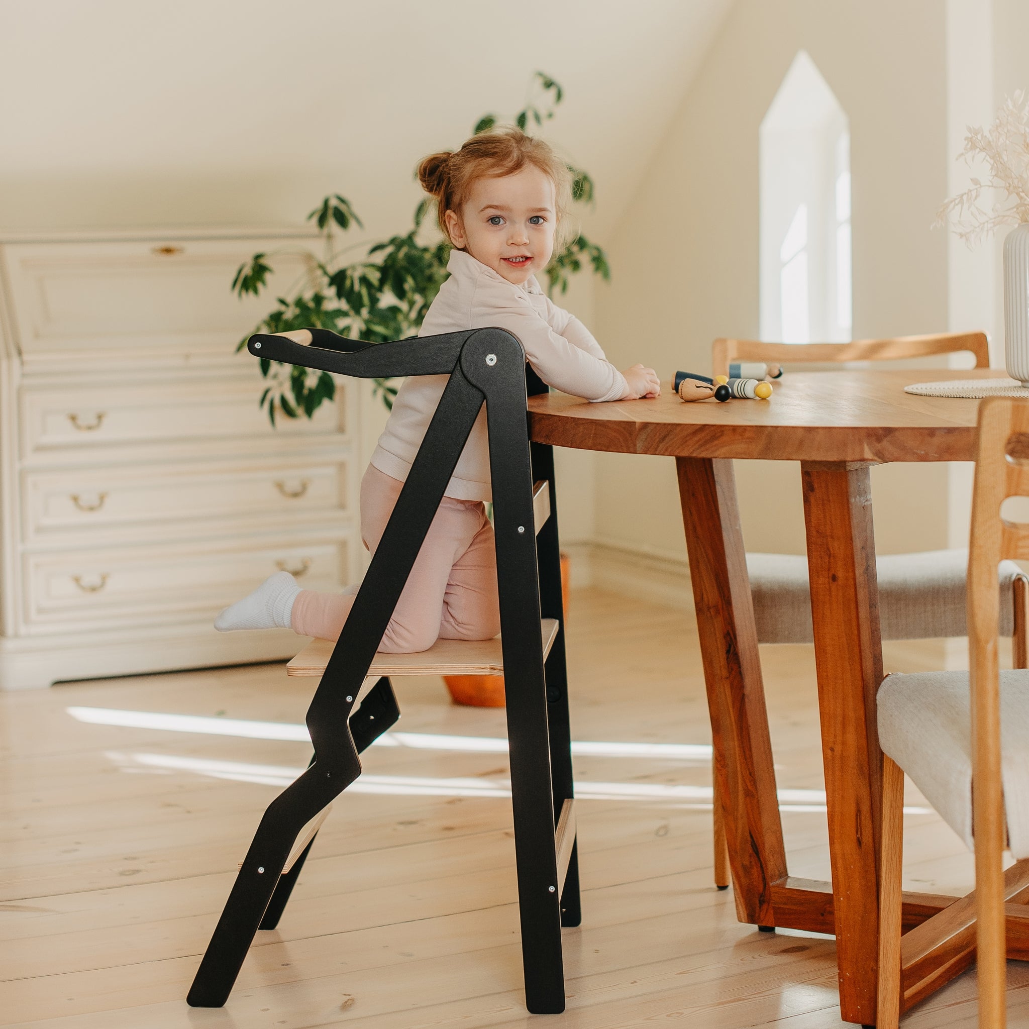 modern black helper tower for toddlers in kitchen interior