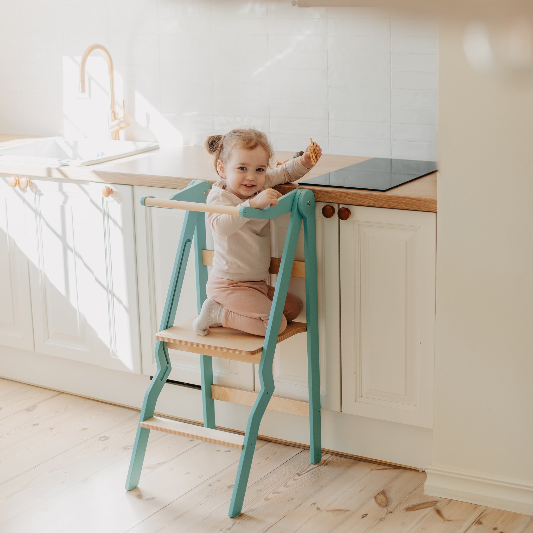 turquoise foldable helper tower for toddlers in modern kitchen
