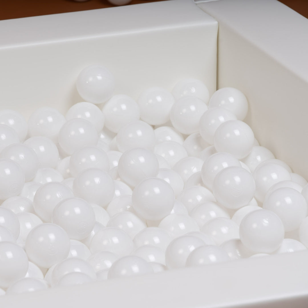White plastic balls in a soft play ball pit