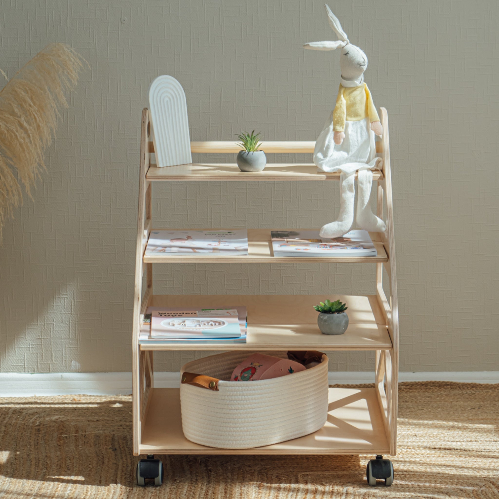 Natural wood kids bookshelf with accessible storage for books and toys