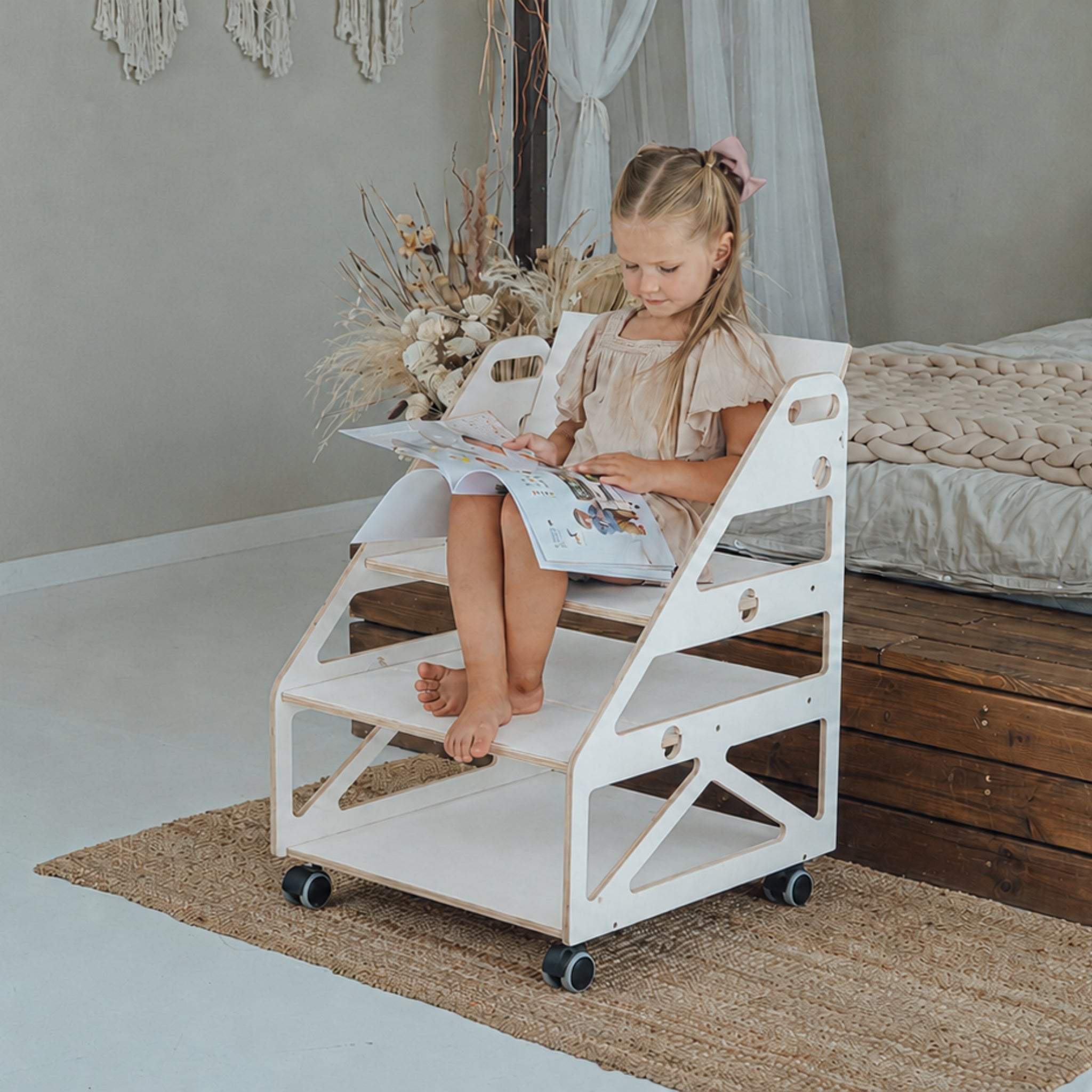 Child using a white Montessori bookcase and toy storage shelf