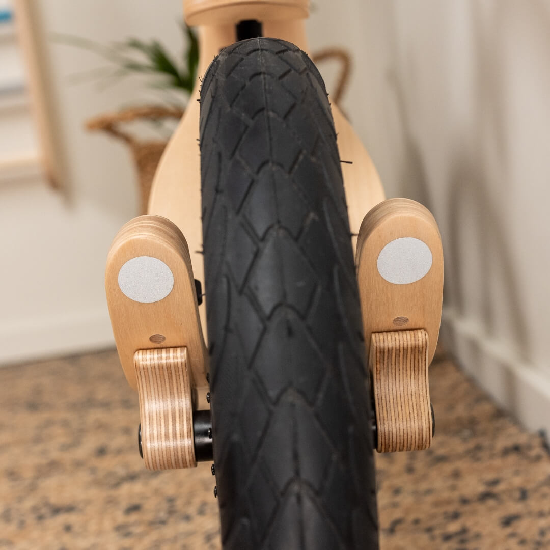 Reflective stickers on Leg&Go wooden balance bike highlighting better visibility