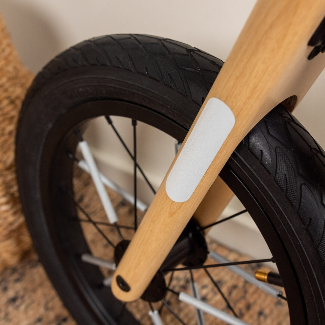 Detail view of reflective stickers enhancing Leg&Go balance bike safety design