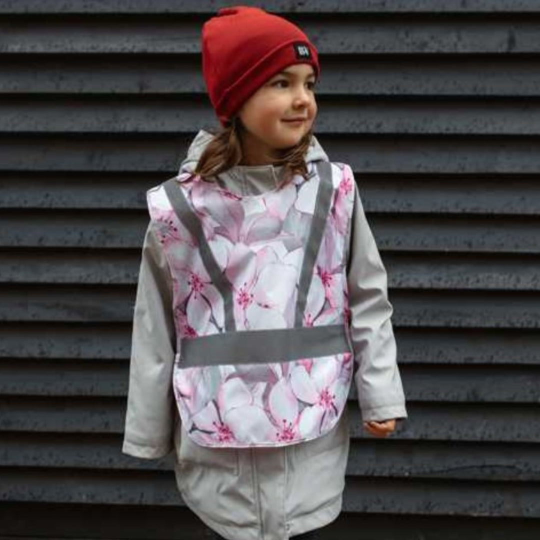 Blossom reflective vest on a young girl, providing visibility during walks or bike rides