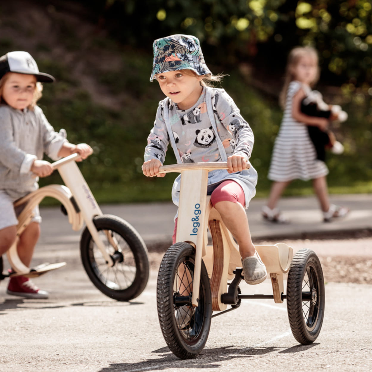 Children racing leg&go bicycles and tricycles and having fun