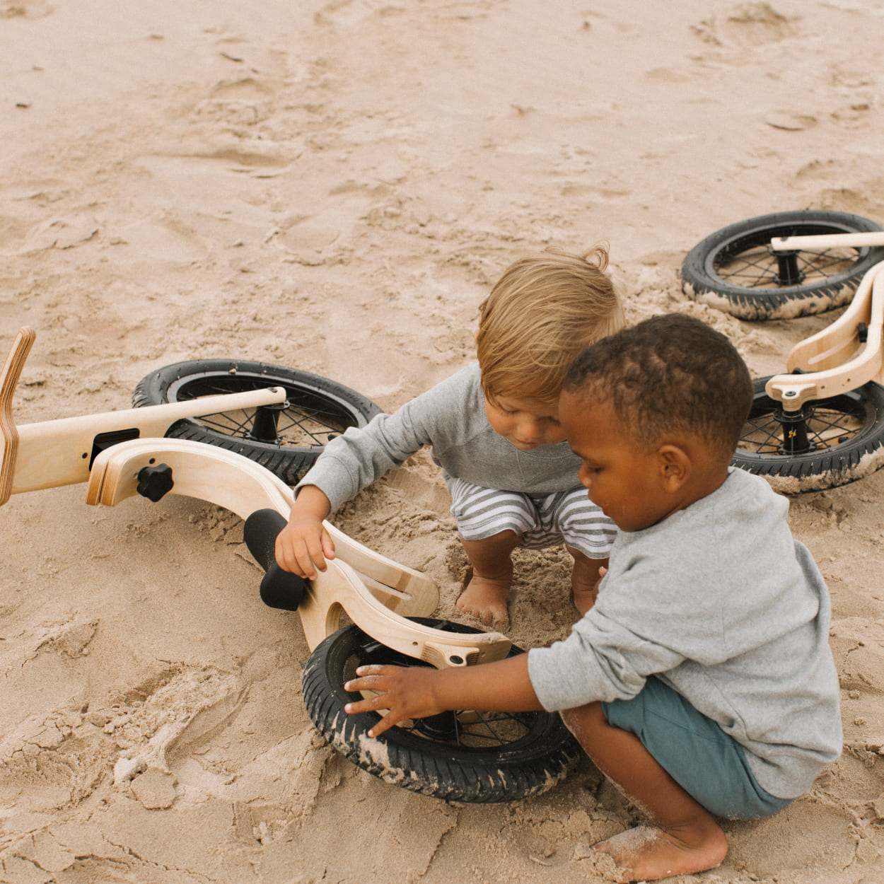 Children checking their wooden balance bikes