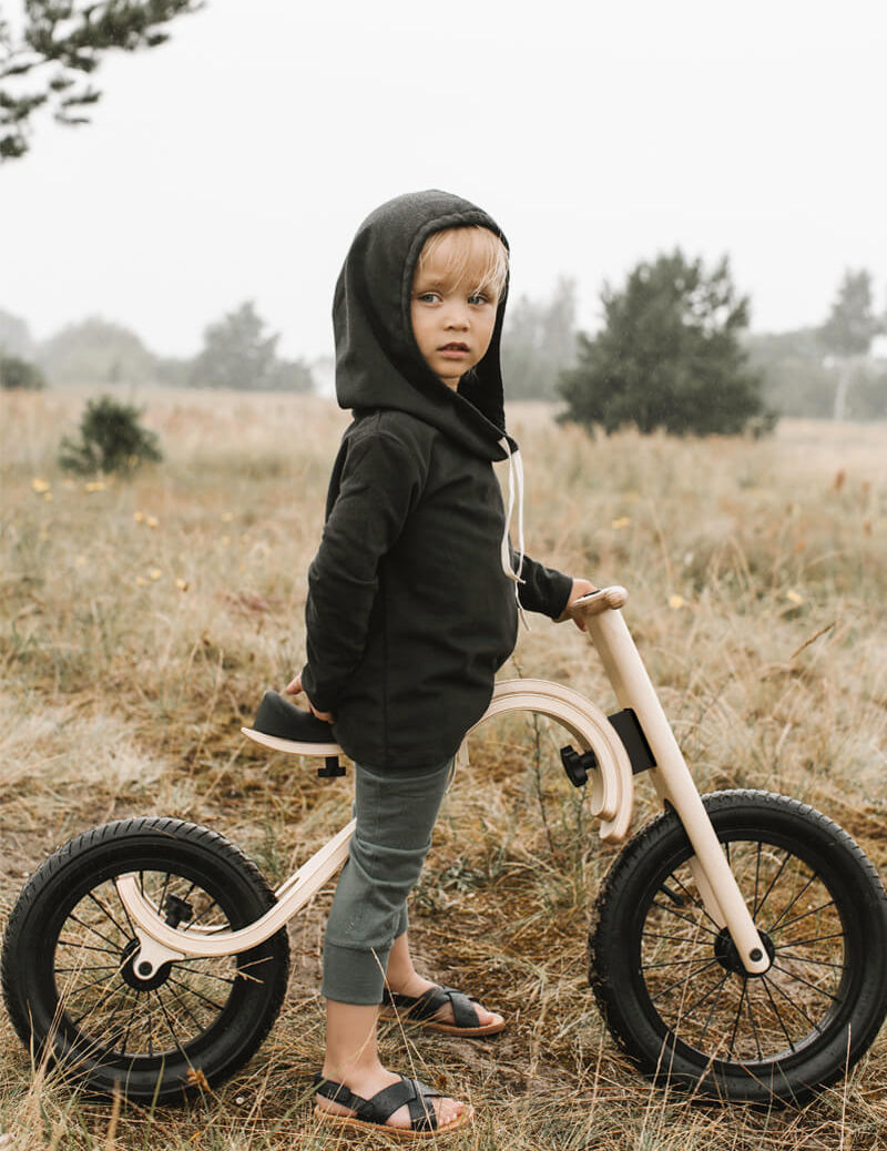 Child riding a leg&go wooden balance bike 3in1 – perfect for developing balance and coordination