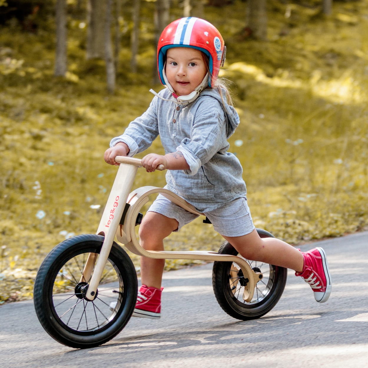 Girl riding leg&go wooden balance bike