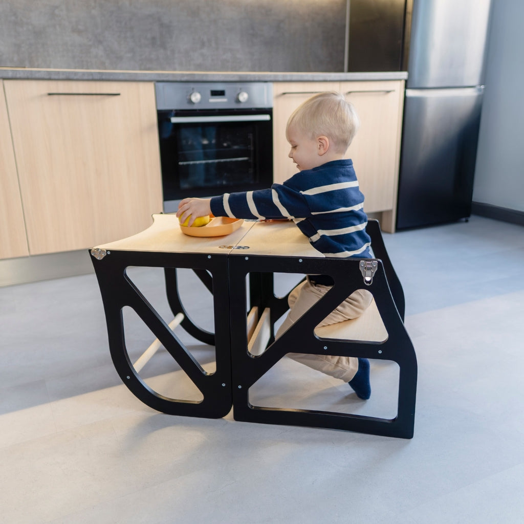 Black adjustable kitchen tower converted into table and chair mode