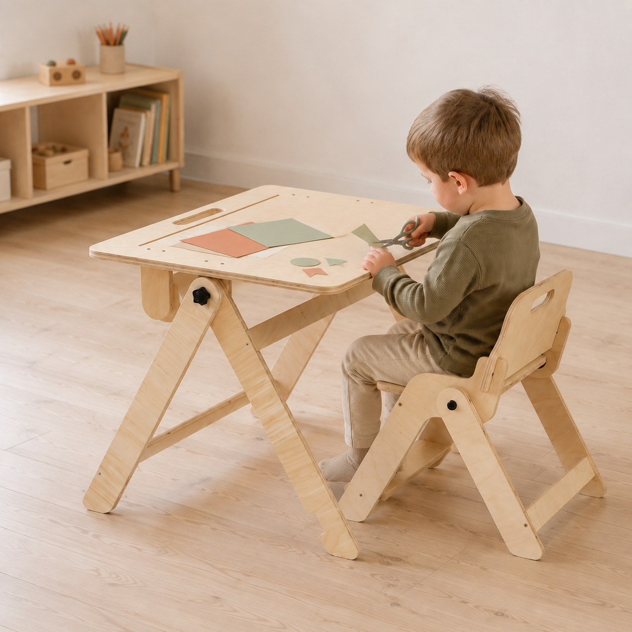 Child sitting on a matching chair and drawing at a foldable kids activity table