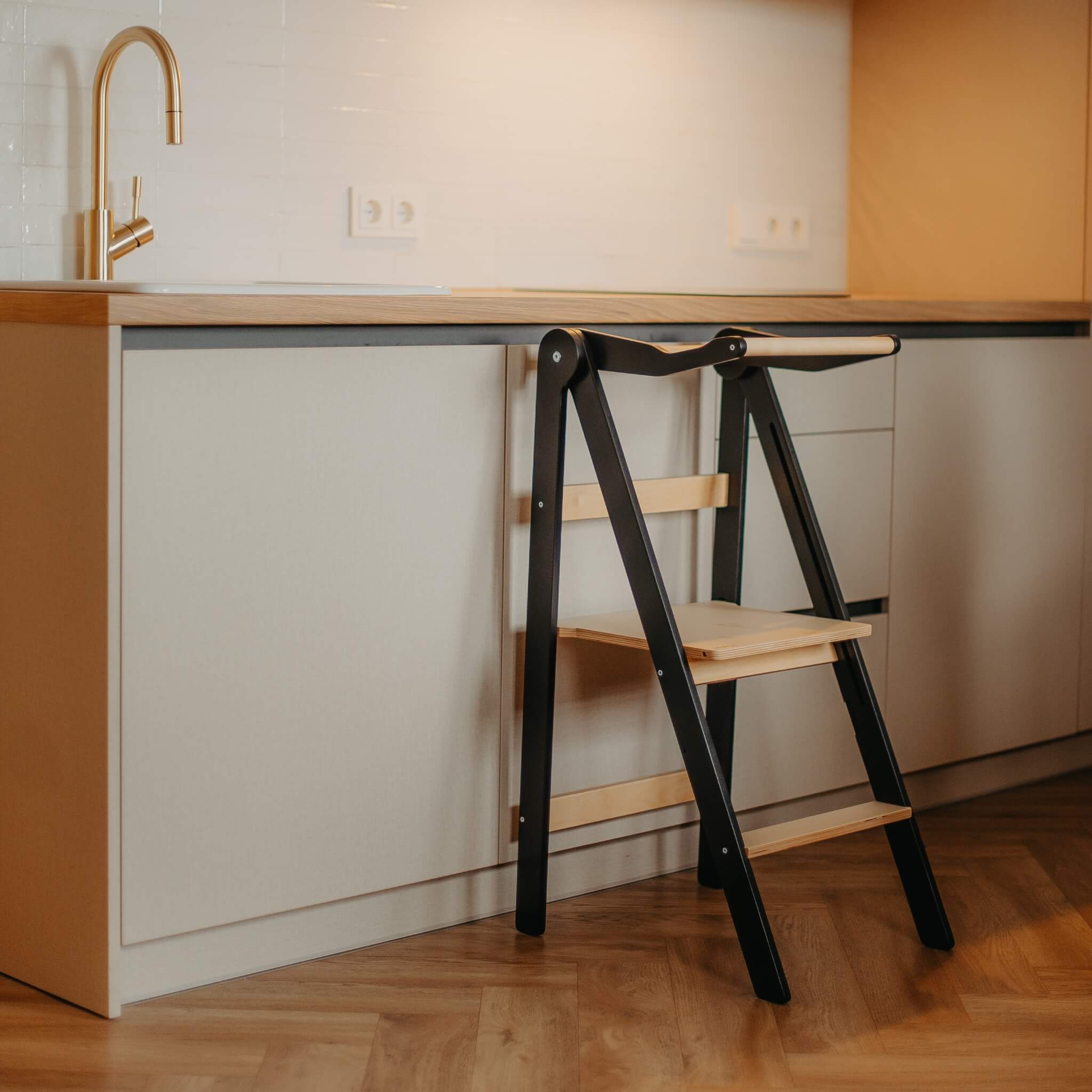 Foldable learning tower in collapsed position demonstrating compact storage feature