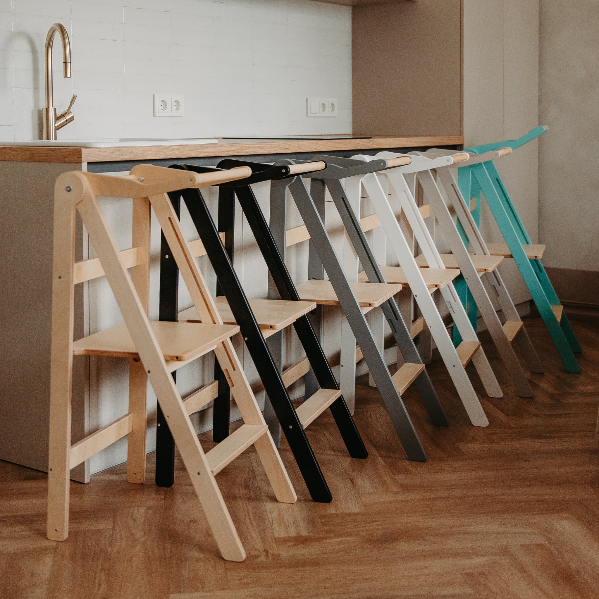 Foldable learning tower available in multiple colors including natural, black, white and gray