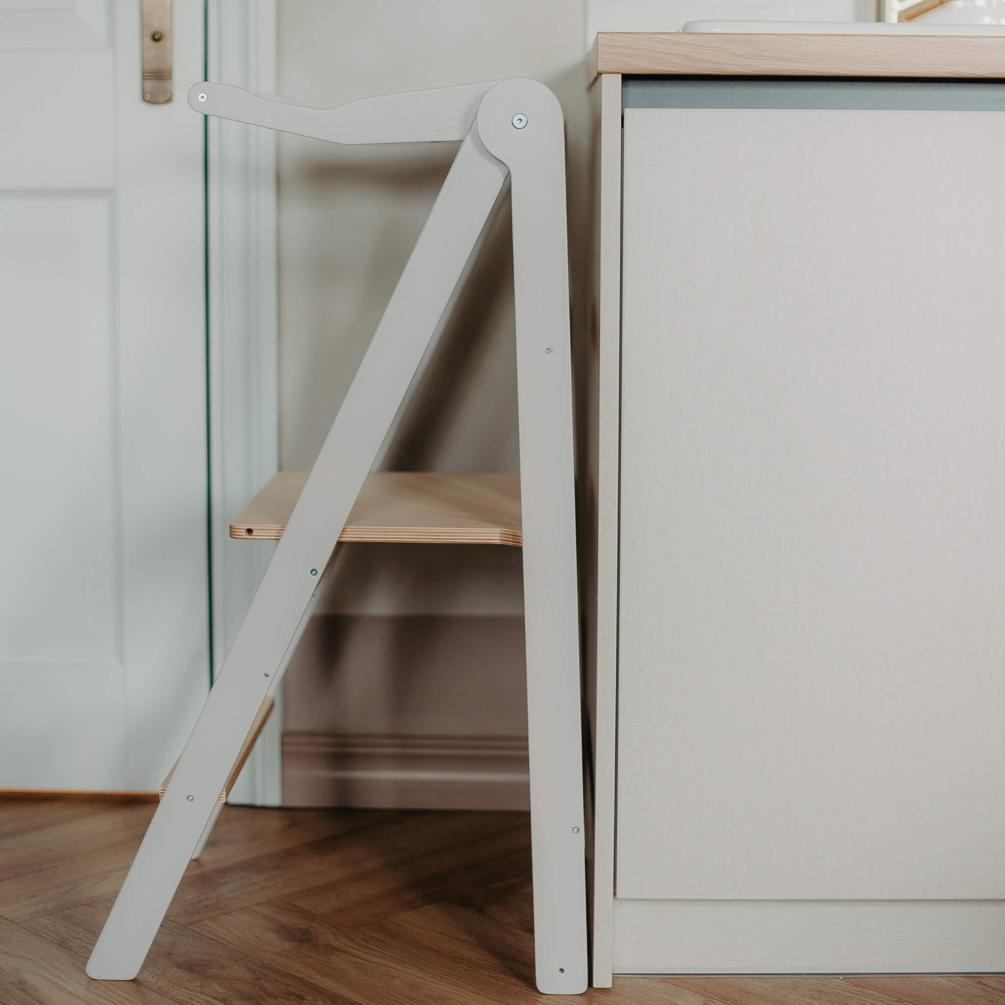 Side view of foldable learning tower showing slim and space-saving storage design