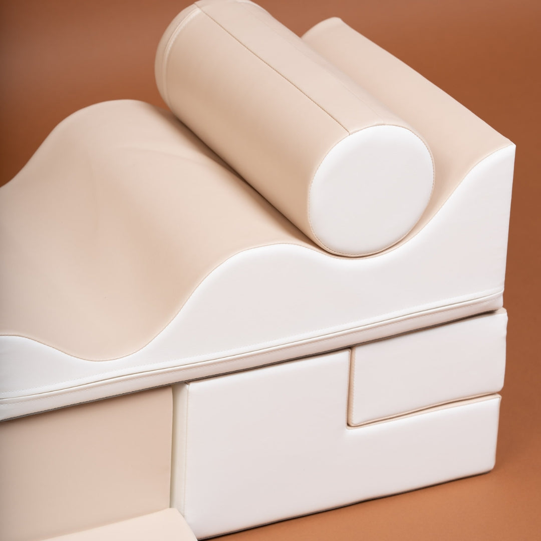 Close-up of stacked beige Explorer soft blocks with curved and round shapes
