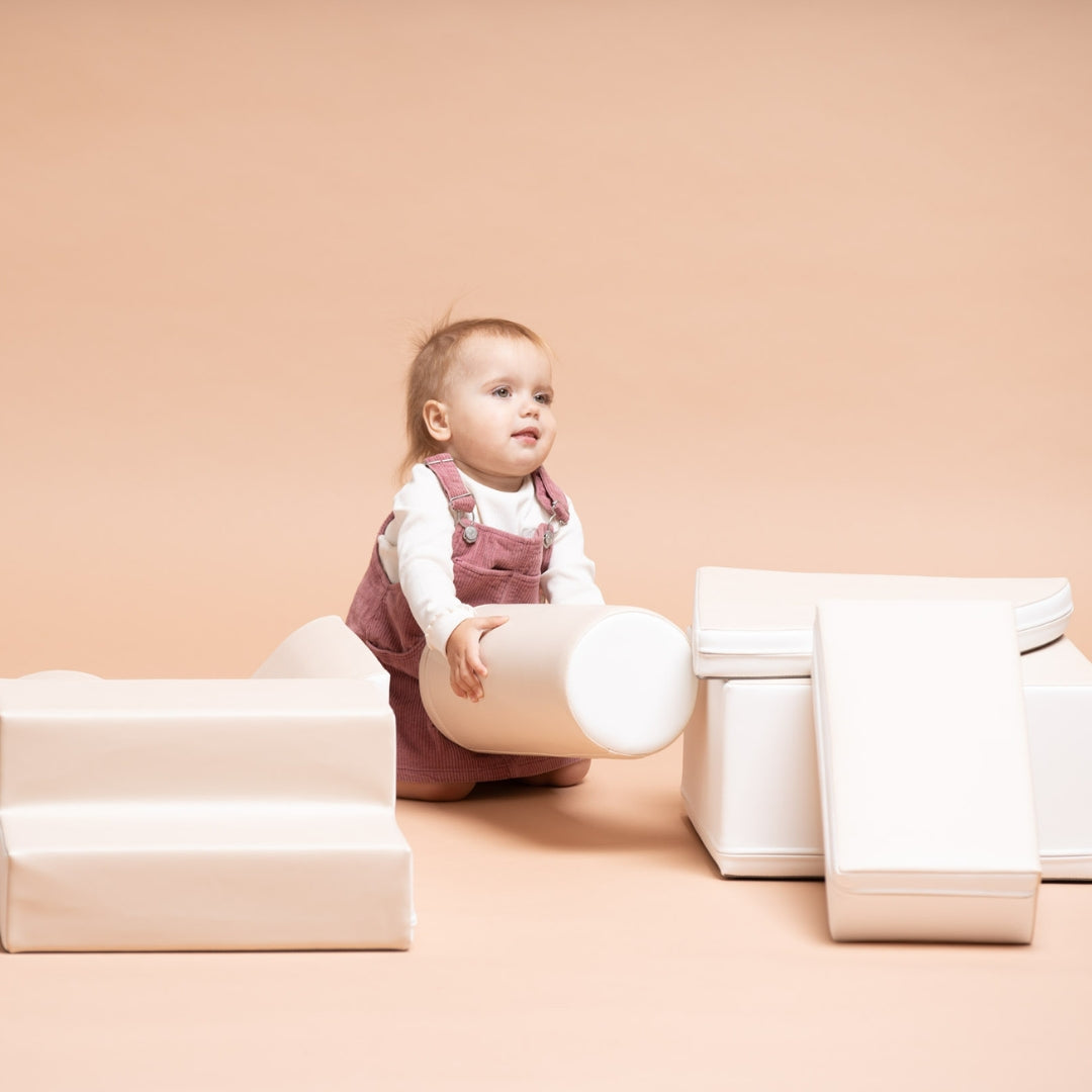 Toddler playing with Explorer soft blocks in beige color palette