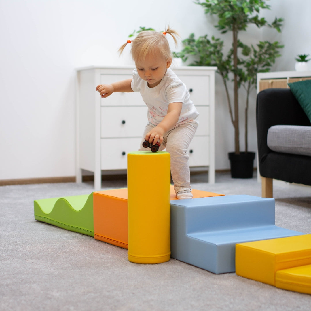 Child playing and climbing on Explorer soft blocks in light multicolor