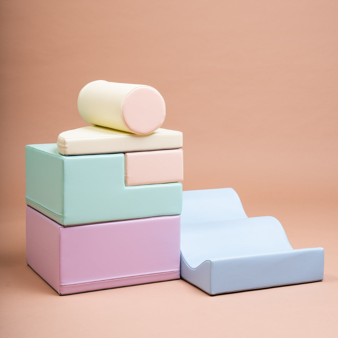 Stacked light pastel soft play blocks from Explorer set on pink background