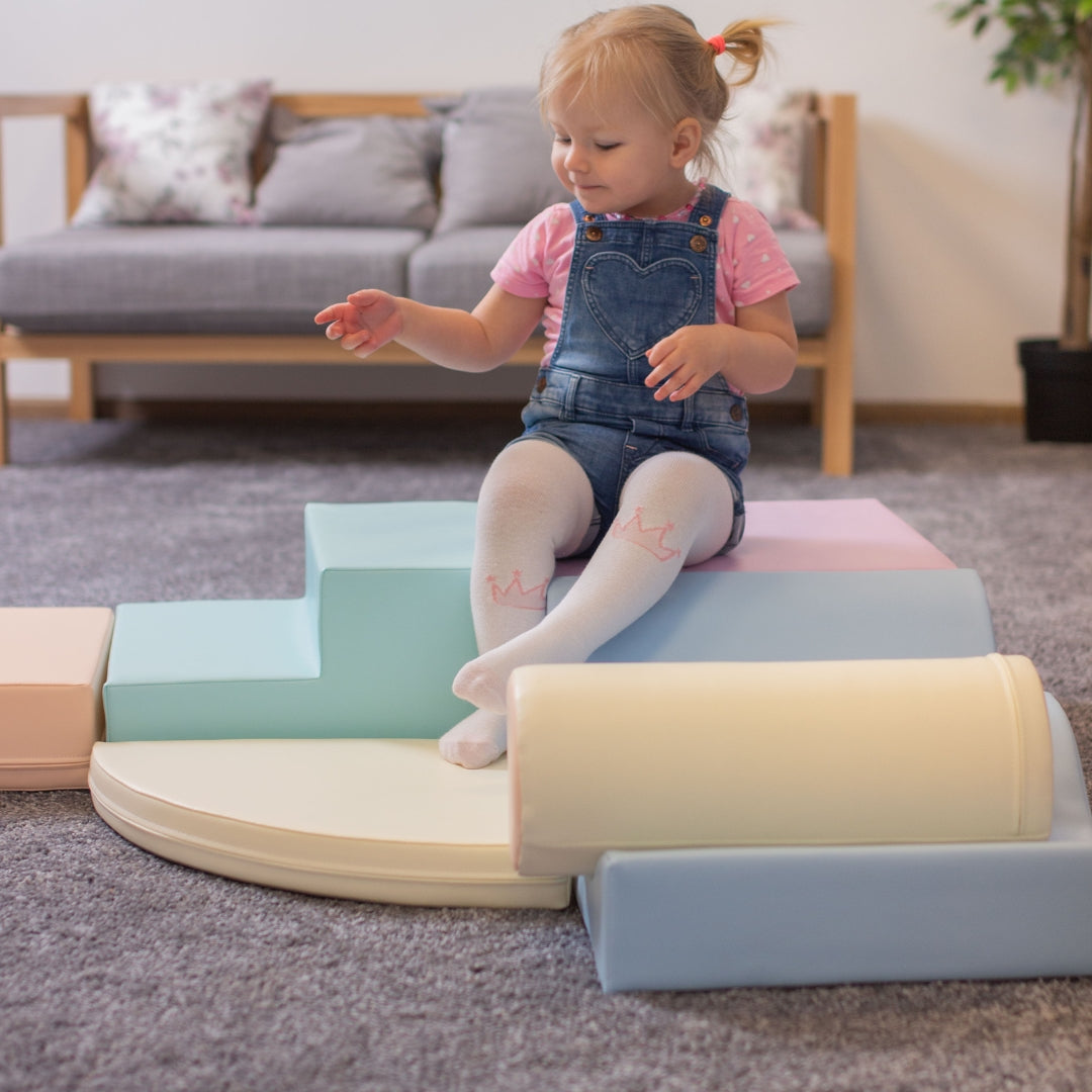 Children playing with Explorer soft blocks in light pastel tones