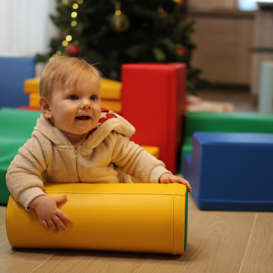 Child playing with bright multicolor Explorer soft block