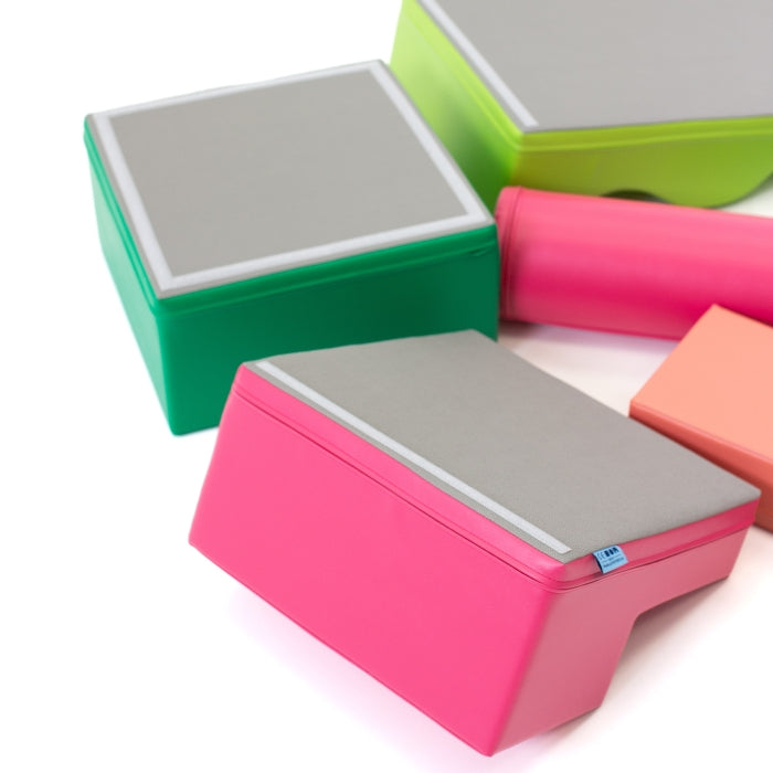 Explorer soft play blocks in pink and green showing the grey non-slip underside surface