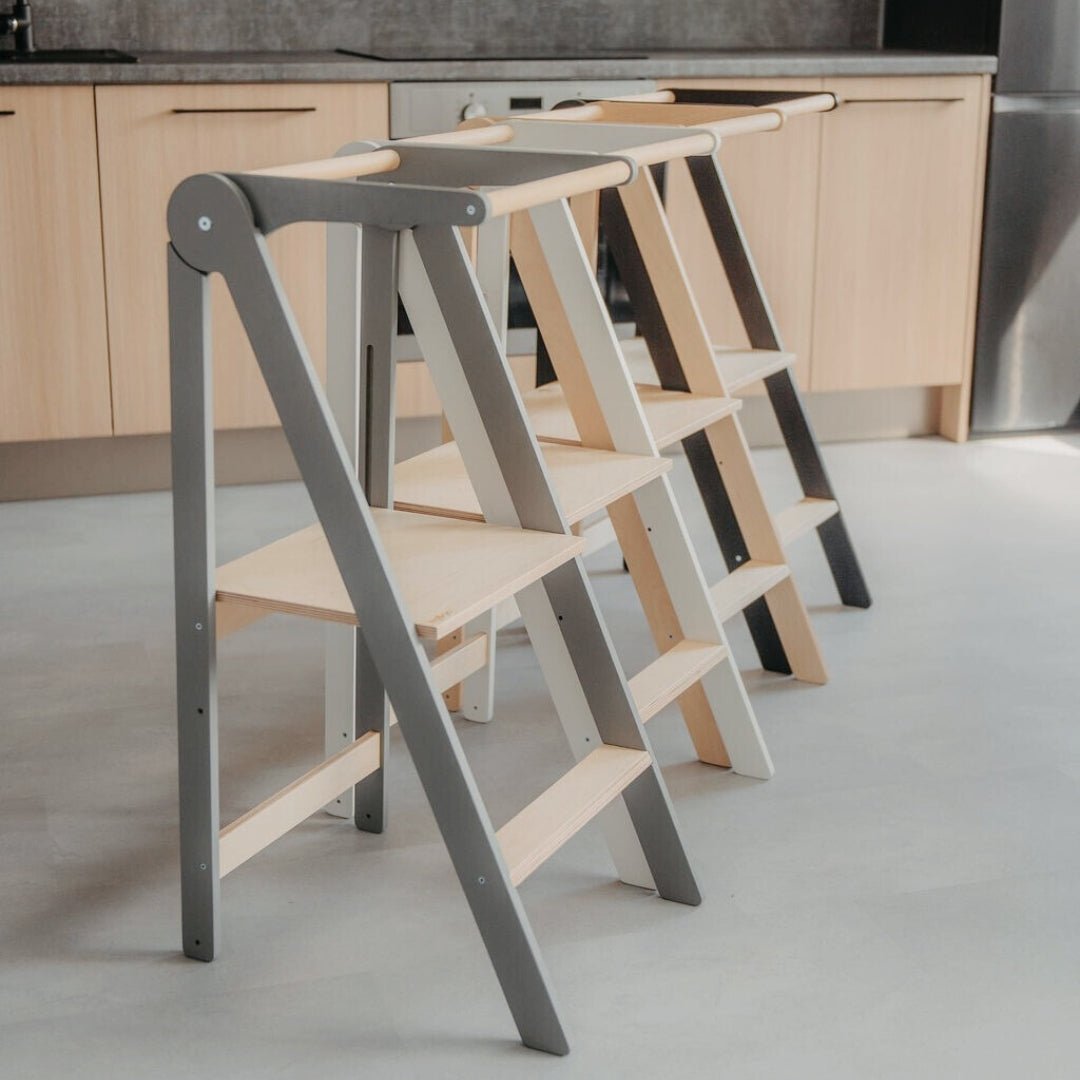 Four kitchen towers with removable rails in different colors – black, white, natural wood, and grey
