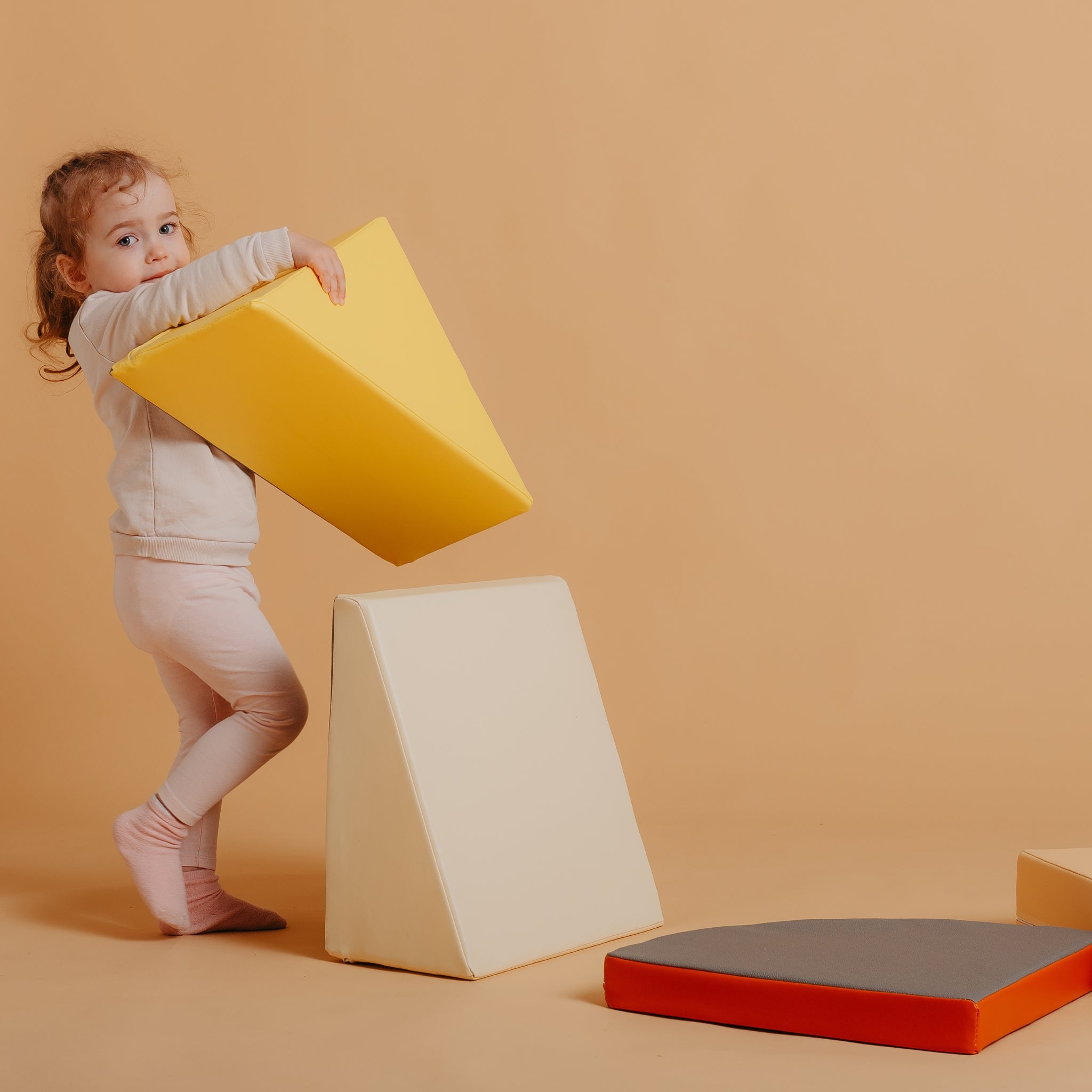 Child building and stacking Kubo Blocks Lumo foam play blocks for imaginative and educational play