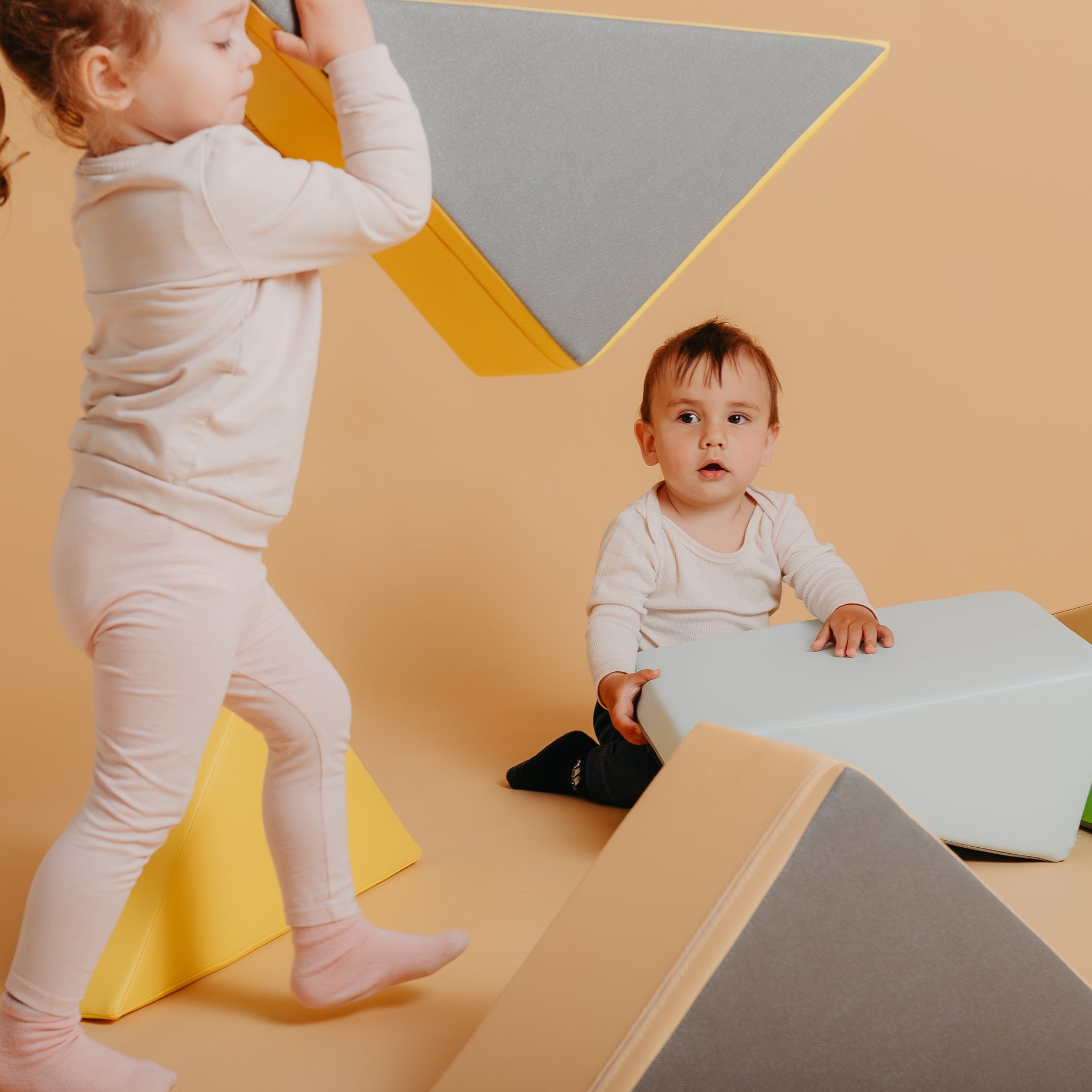 Toddler enjoying Kubo Blocks Lumo sensory play blocks for climbing, balancing and creative exploration