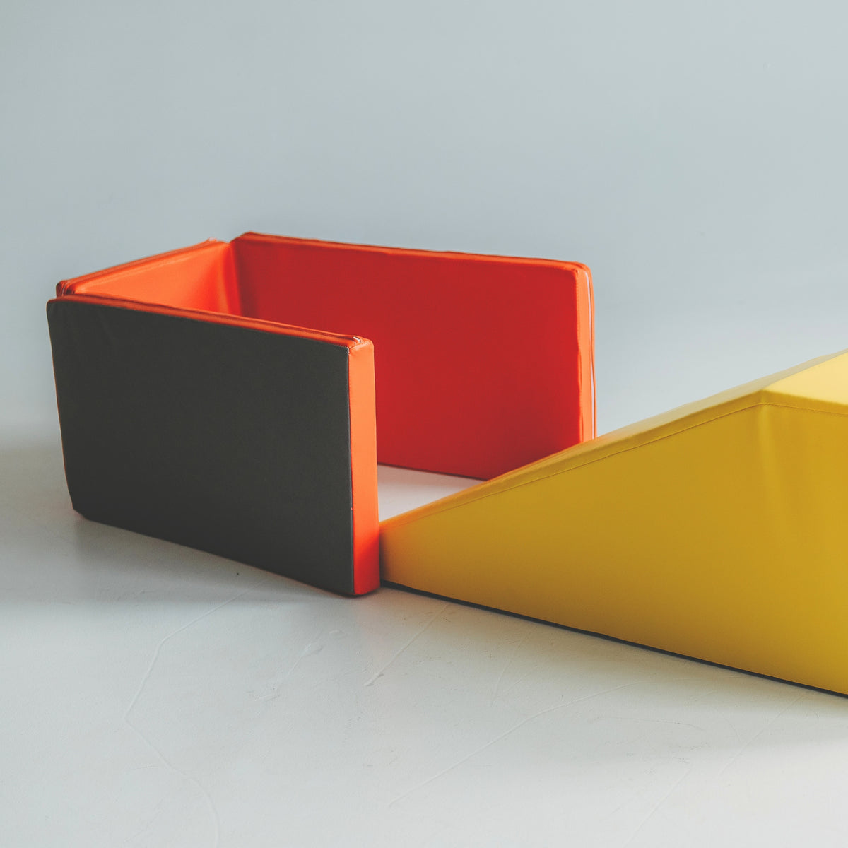 Close-up of the orange Kubo Blocks MATO play mat with its grey anti-slip underside