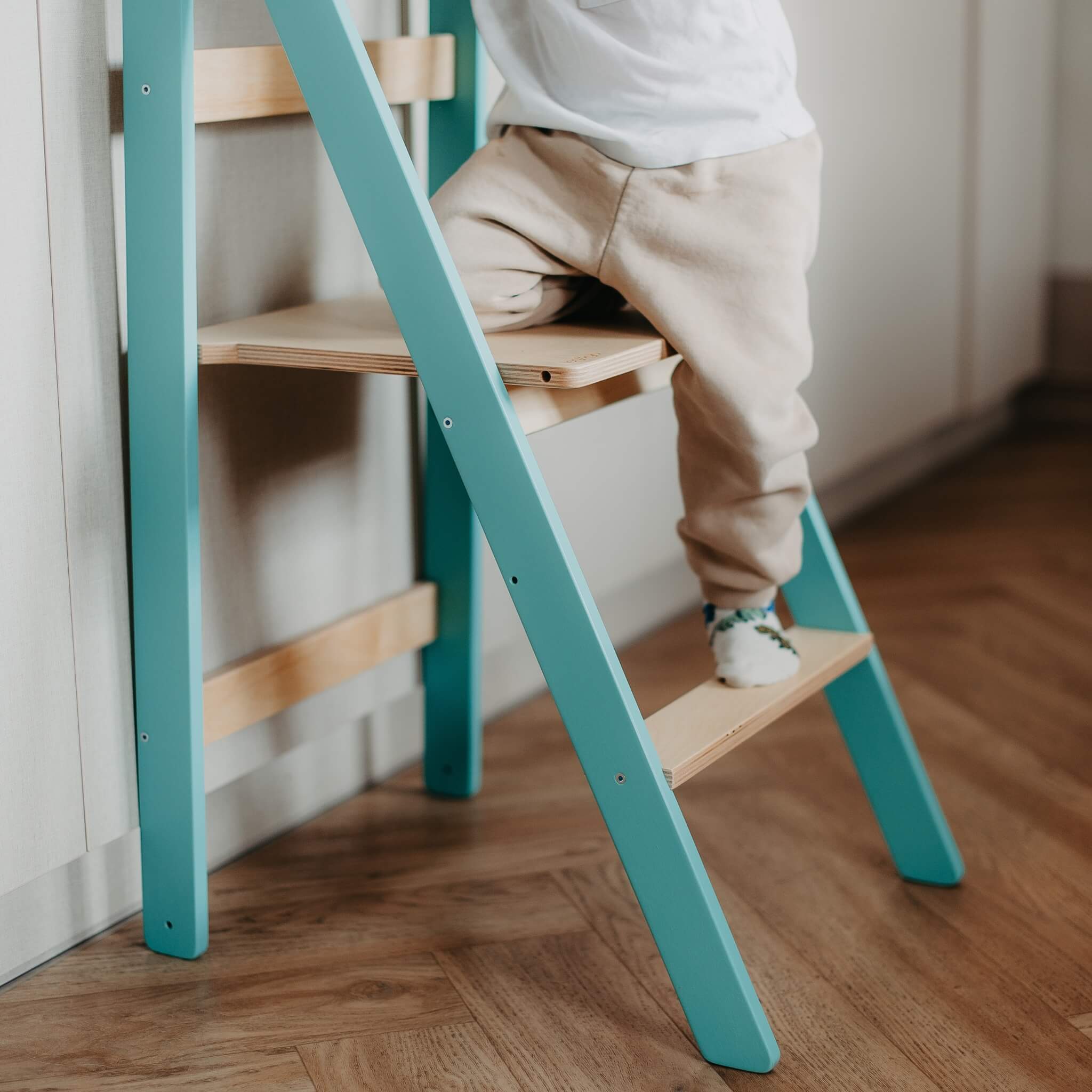 Close-up of learning tower steps designed for safe toddler climbing