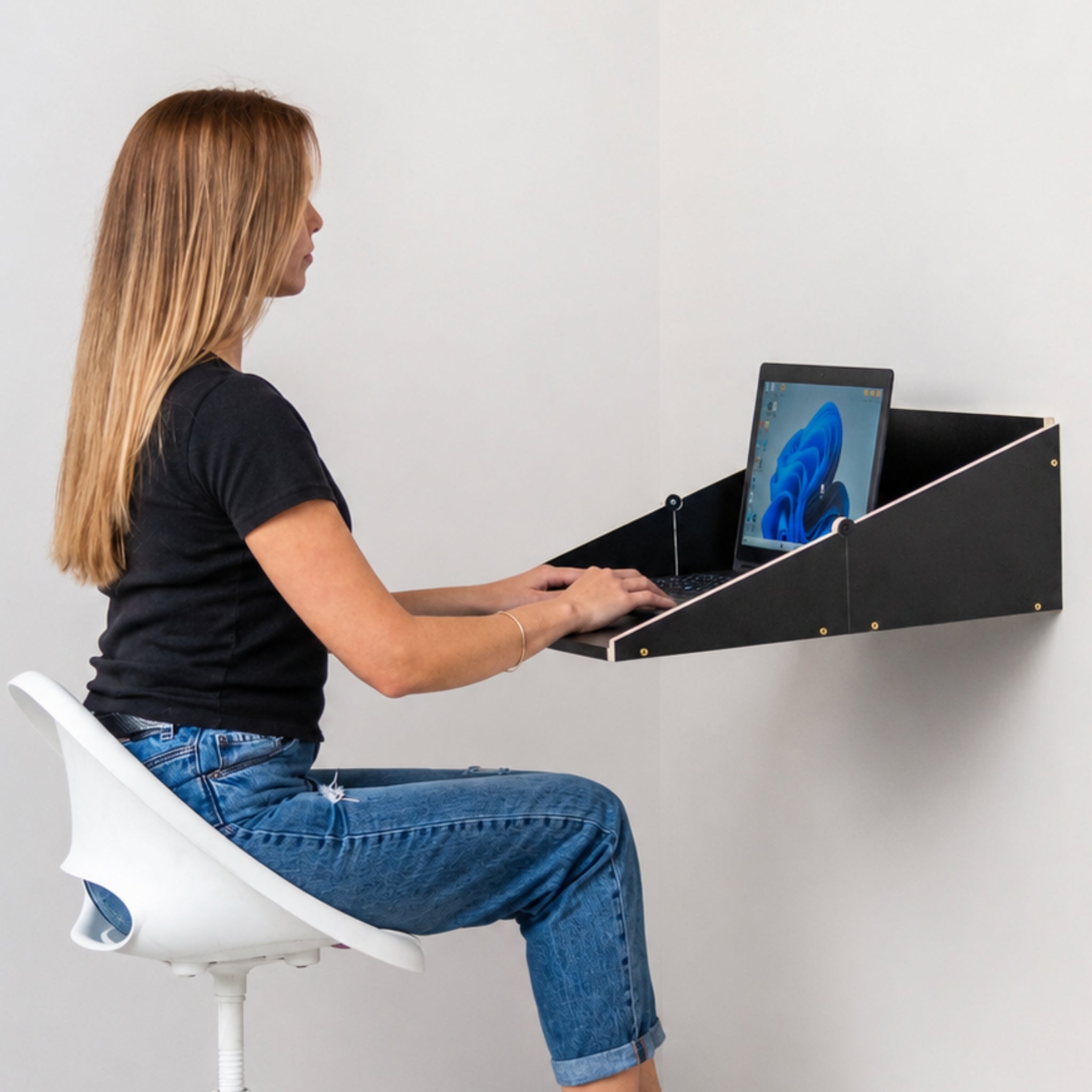Woman working at a Murphy Desk wall mounted folding desk