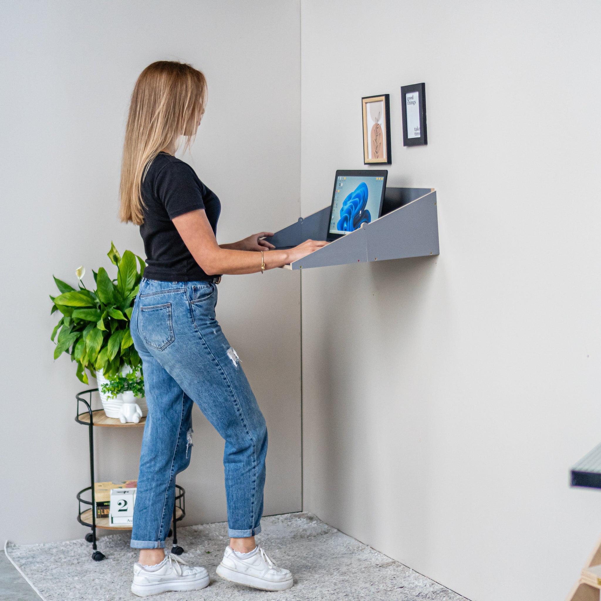 Standing workspace using a gray wall mounted Murphy Desk