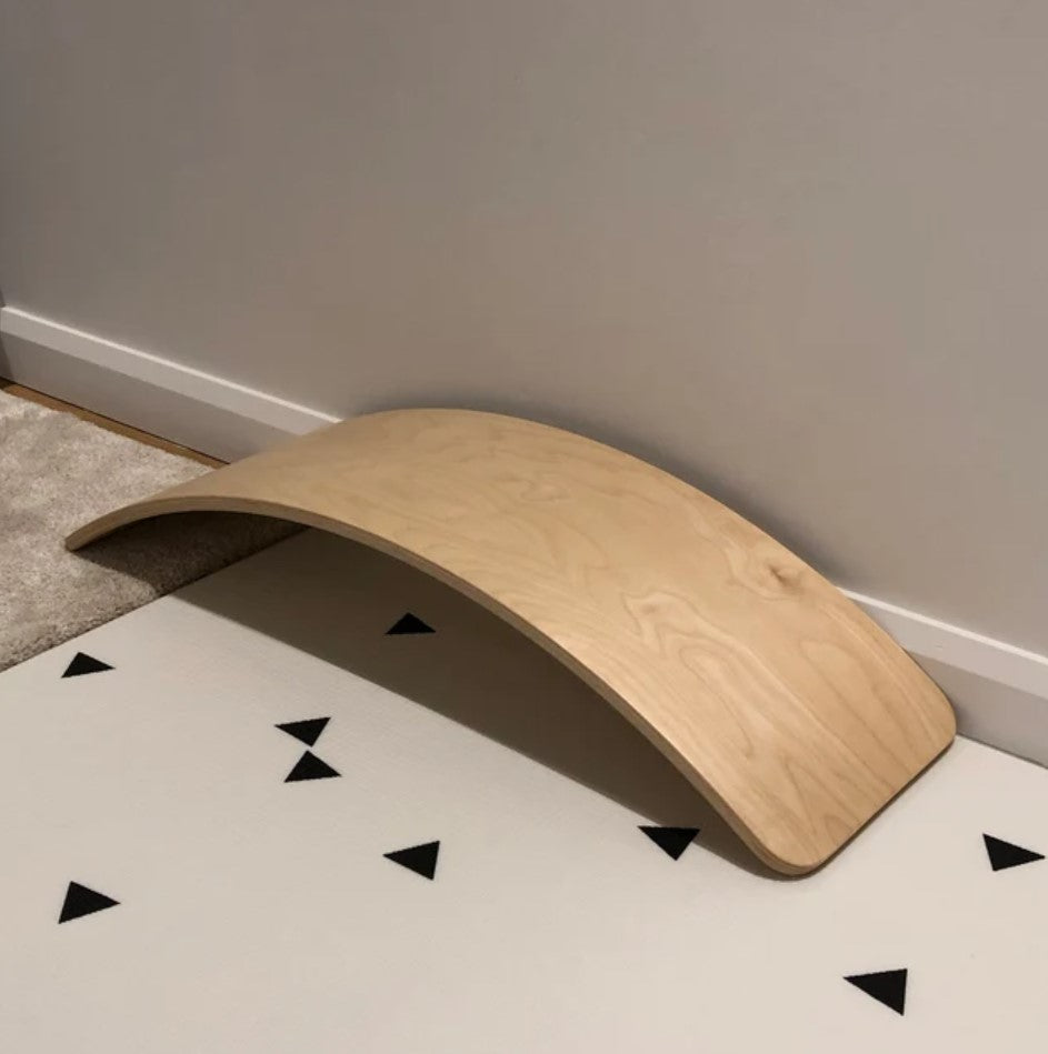Wooden balance board designed for children to improve balance and coordination