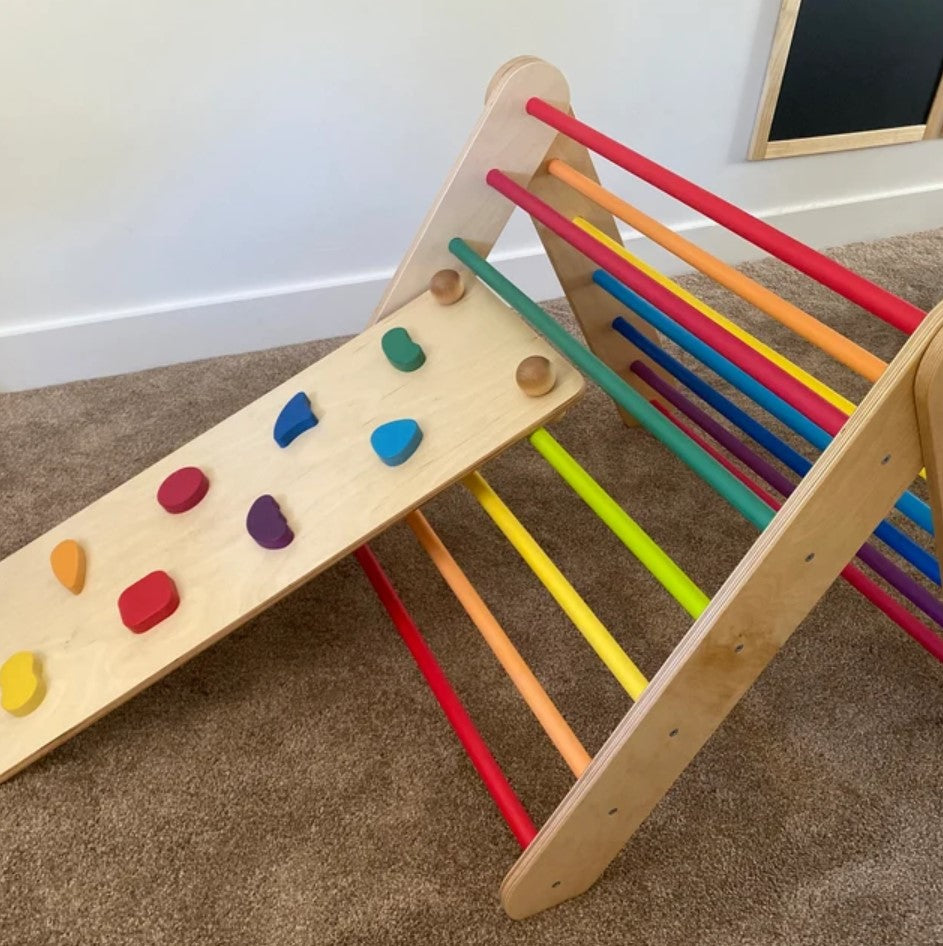 Colorful wooden climbing triangle which can be transformed into a climbing Swedish wall with colorful ramp